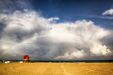 Fototapeta na wymiar Miami Beach lifeguard tower after storm with rainbow.