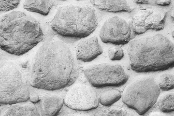 Old, vintage black and white stone rock wall.
