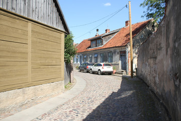 Old countryside brick road with wood house.