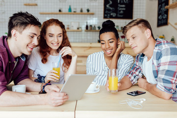 multiethnic friends with digital tablet