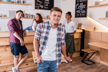 cheerful boy with friends in cafe