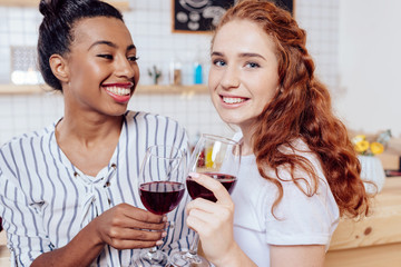 multiethnic girls drinking wine