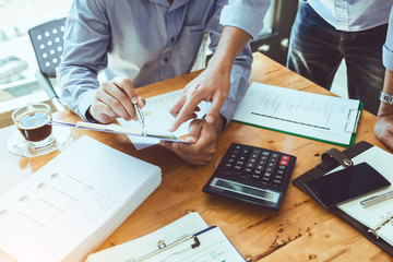 Teamwork business officer working hard investing financial reports and calculating colleagues for...