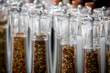 Close up picture of dried spices in glass jars