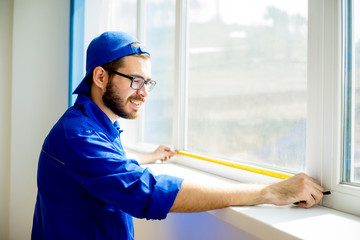 Construction worker installing window