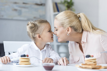 mother and daughter having breakfast