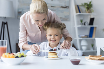 mother and daughter eating pancakes