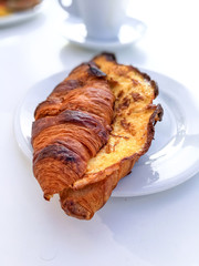 Breakfast with coffee and croissants on table