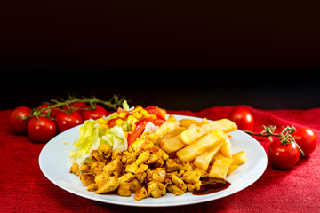 Fresh chicken steak with tomatoes and french fries