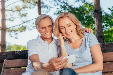 senior couple using smartphone together