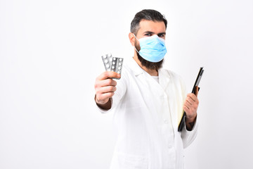 Man with stylish haircut holds black folder, offering pills.