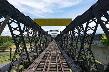 perspective view of old railway bridge at sunny day and soft cloud background