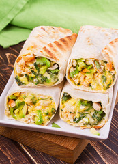 Wraps with chicken, avocado, cilantro and cheese. Chicken burrito