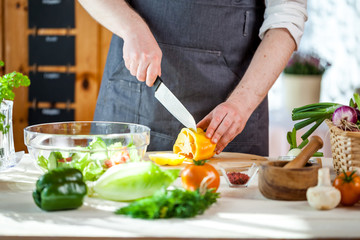 Chef cutting fresh and delicious vegetables for salad