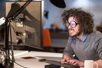 man working on computer in dark startup office