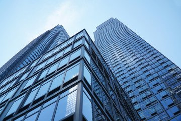Fototapeta na wymiar low angle view on modern office building with blue glass windows