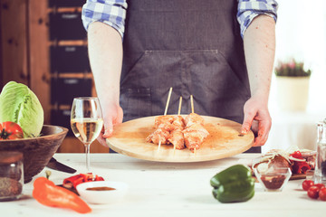 male preparing chicken for cooking