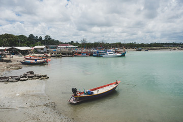 Fototapeta na wymiar Colorful fishing boats docking in harbor.