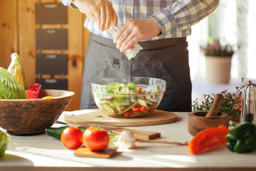 Obraz na płótnie Canvas male cooking healthy salad