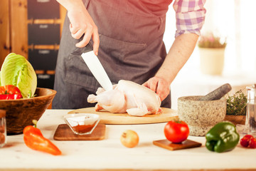 male preparing chicken for cooking
