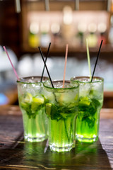 Three glasses of mojito on the bar