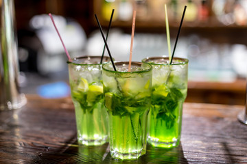 Three glasses of mojito on the bar