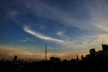 Night is Coming, Sunset Paradise with red and blue sky, cloud and building in big city. Business background concept with copy space, low key.