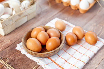 Close-up view of raw chicken eggs on wooden background