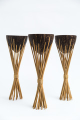 Old exotic tropical eastern wooden three coconut torches on white background