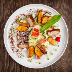 salad with fresh vegetables grilled veal and baked potatoes