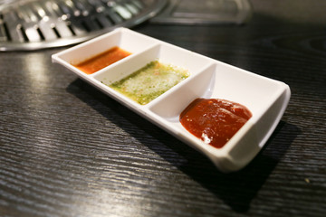 red bbq sauce on white bowl on wood table