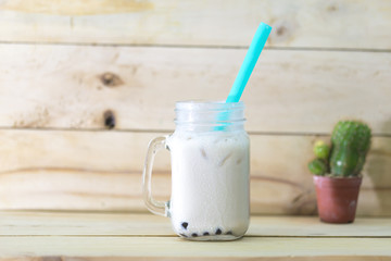 Ice mixed milk and tea with bubble in a cup.