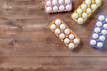 Raw eggs on wooden table, top view, free space