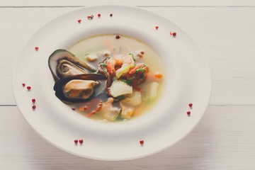 French seafood soup with white fish, shrimps and mussels in plat