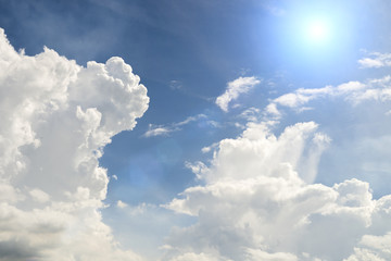 sun on blue sky with white clouds