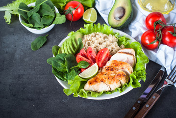 Fresh salad from quinoa, chicken breast, spinach, lettuce and tomatoes