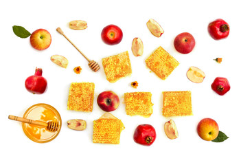 Honey in glass bowl, honey in honeycombs, red apples, garnets, wooden honey dipper and orange flowers on a white background. Top view, flat lay