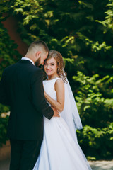 Fototapeta premium Beautiful bride and groom couple walking at the wedding