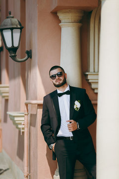 Portrait of the groom on a wedding day walk