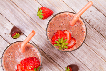 Milkshake with chocolate and strawberries. Chocolate strawberry smoothie. View from above, top studio shot
