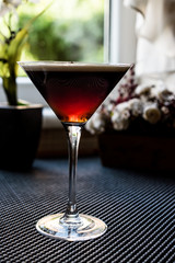 Black Cocktail in front of the window.