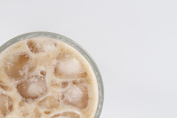 Ice tea with milk over white background