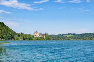 Fototapeta na wymiar Lake Fuschlsee and Fuschl castle in summer, Salzburg state, Salzkammergut, Austria, Europe