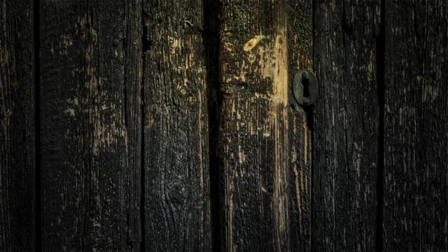 Old barn door with keyhole.