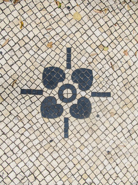 Traditional portuguese pavement (calcada portuguesa) with flower detail