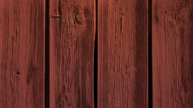 Close up of aged, weathered wooden wall of an old barn. Animated still picture.