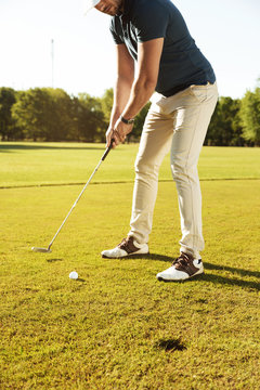 Male golfer about to tee off a golf ball