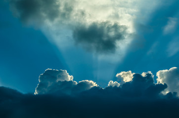 blue and white clouds with light rays