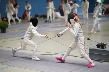 Girl and Boy fencing Foil at a tournament