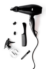 Hairdryer and hairdresser tools in beauty salon on white background top view